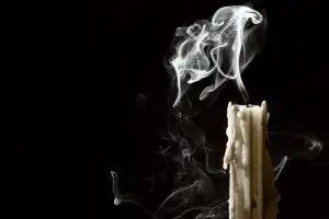 Photo of a candle being blown out.