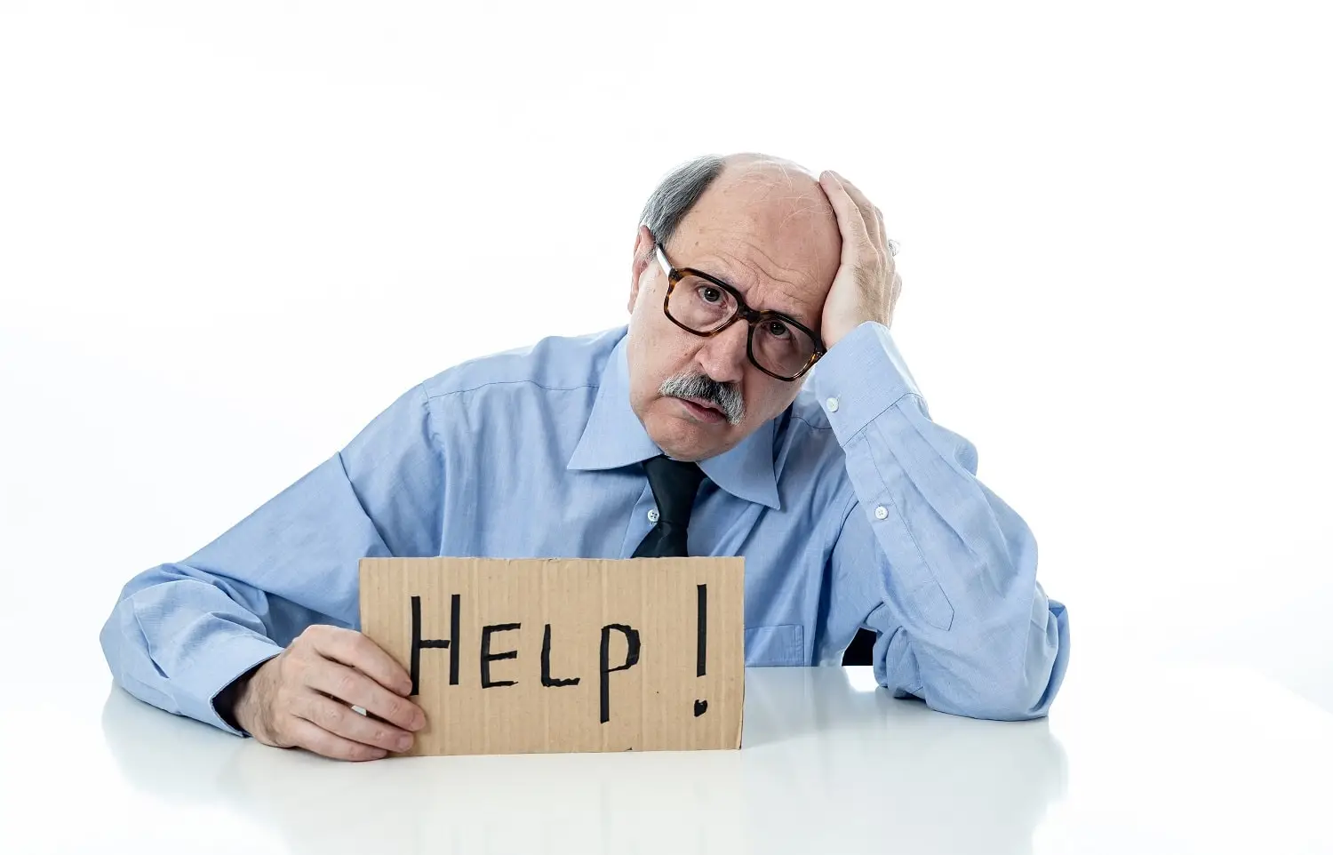 Photo of a bored employee holding a sign asking for help.