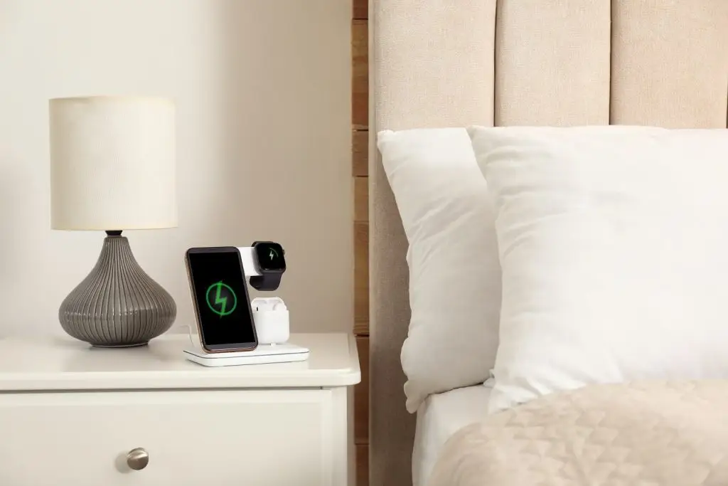 Photo of devices charging on a nightstand.