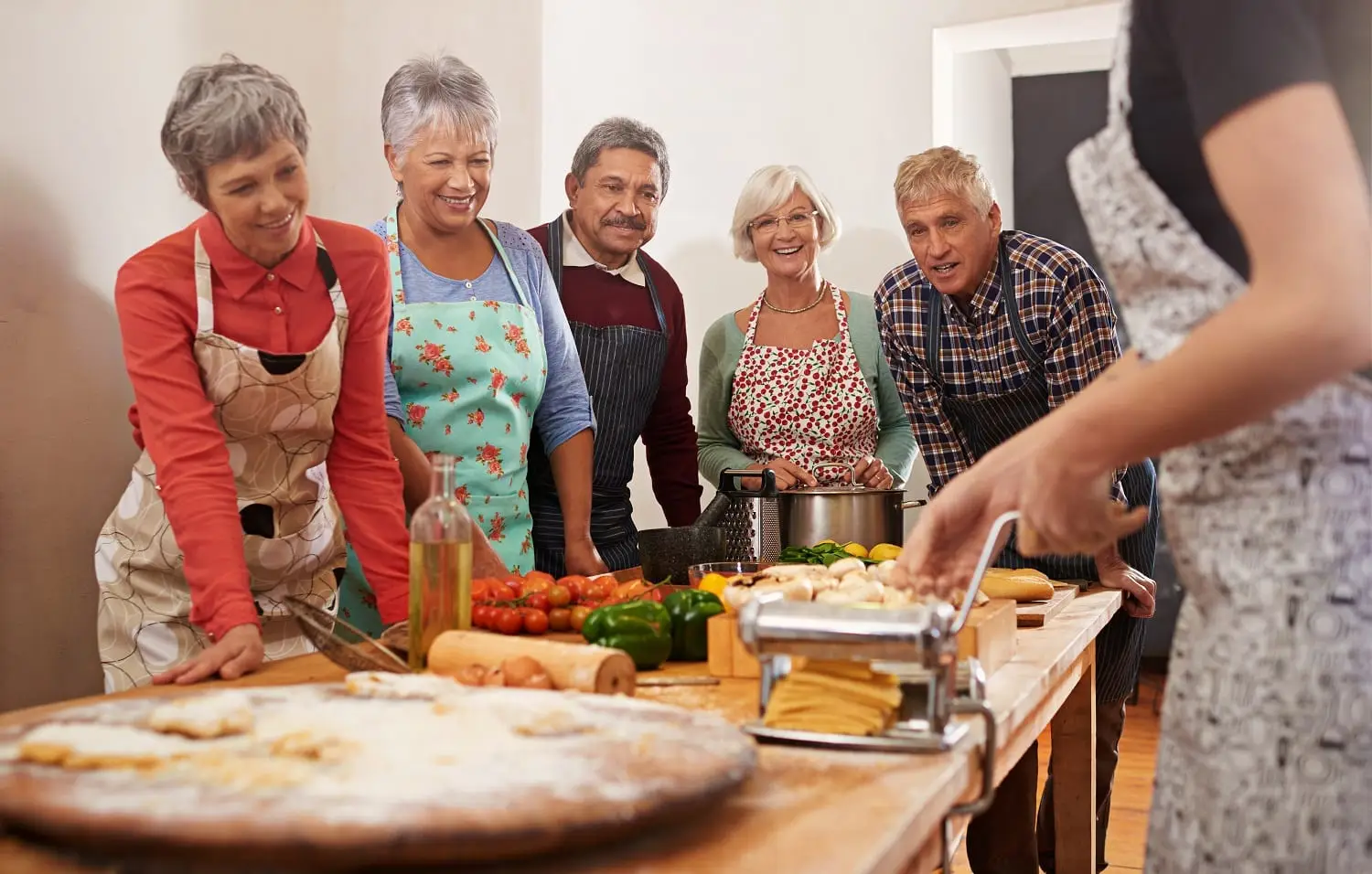 Photo of a woman leading a cooking class for older people.