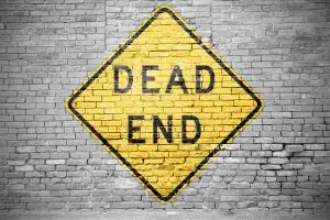 Photo of a dead end sign painted on a wall