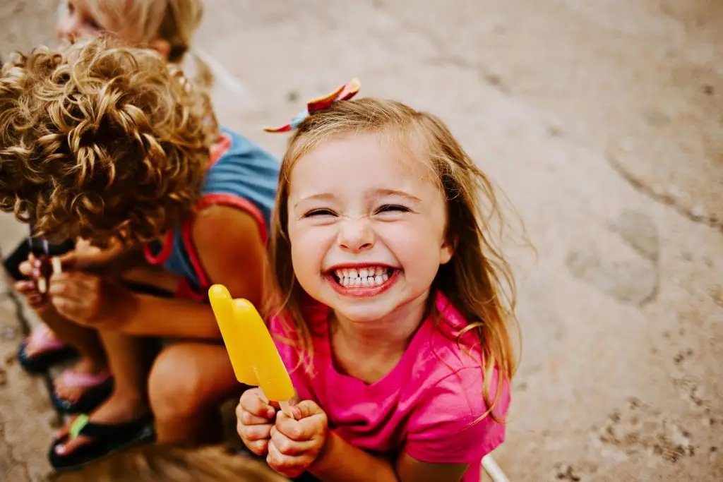 Picture of a girl eating a popsicle