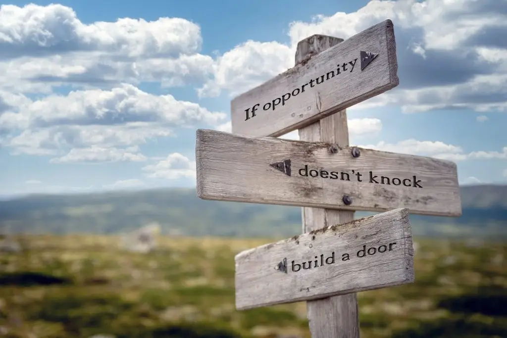 Photo of signs saying if opportunity doesn't knock, then build a door.