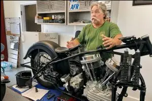 Photo o Jeff Powell working on a modified motorcycle. Photo from NWF Daily News