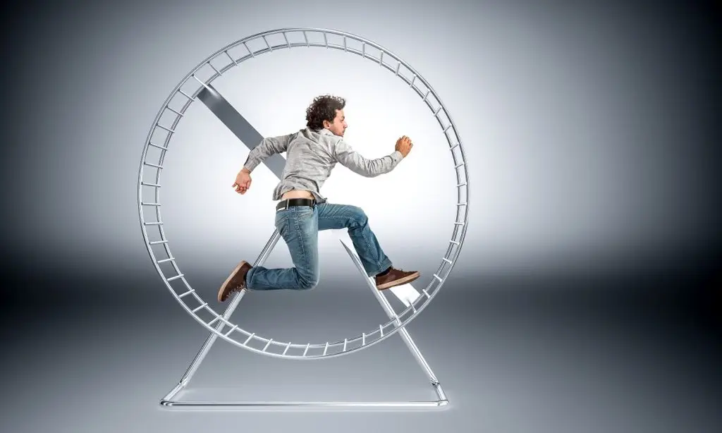 Photo of a man caught in a hamster wheel.