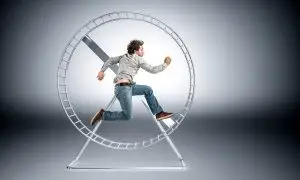 Photo of a man caught in a hamster wheel.