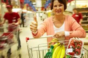 Photo of an older woman with a shopping cart.