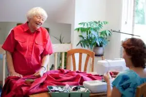 Photo of two senior women working on a sewing project