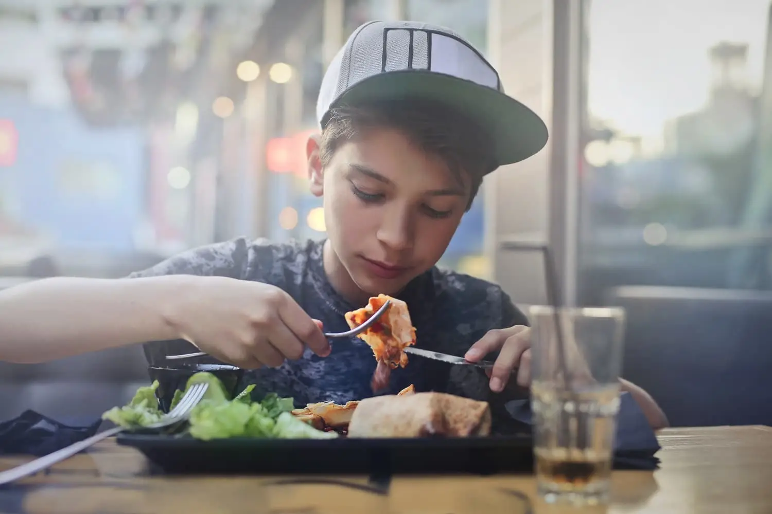 Photo of a young teen eating a meal.
