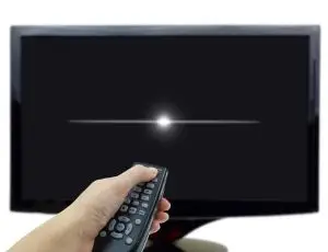 Photo of someone turning off a television.