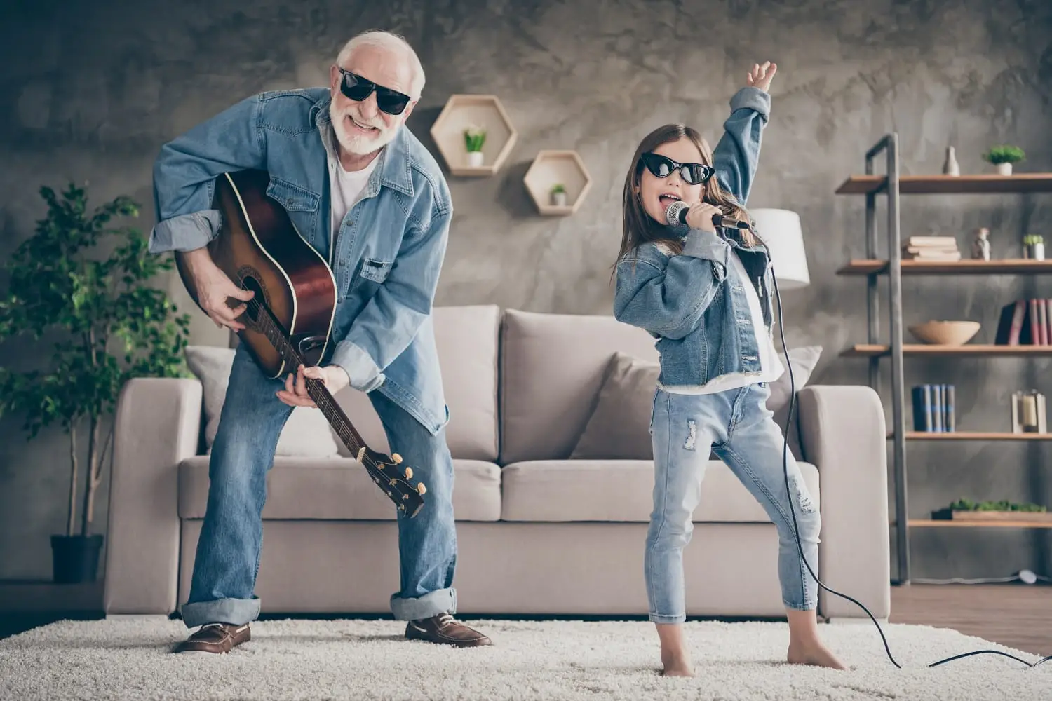 Photo of a guitar-playing grandfather and his singing granddaughter.
