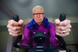 Photo of an older man working hard or working out.