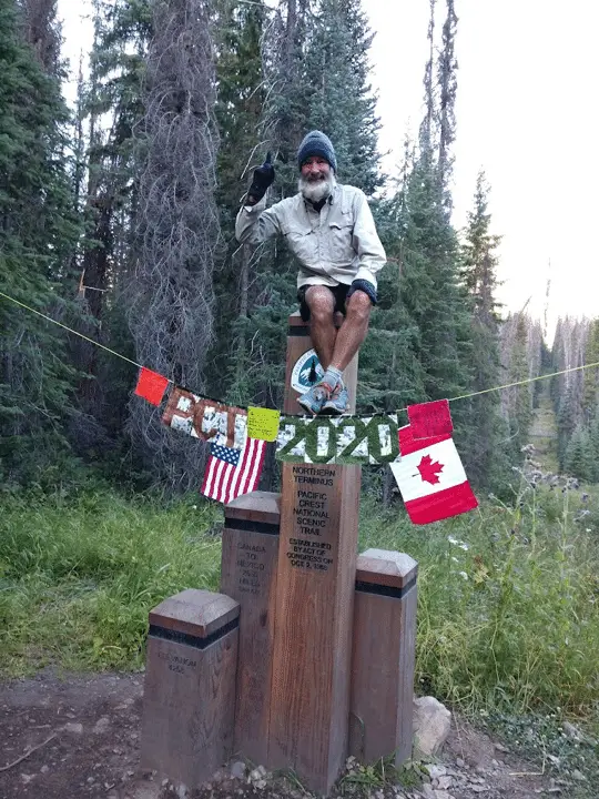 Photo of Perry Gabbard celebrating the completion of hiking the Pacific Crest Trail.