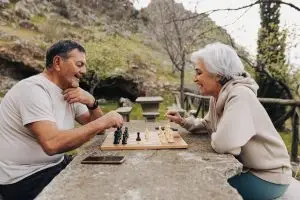 Photo of an older couple playing chess