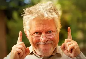 Photo of a man pointing as though he just had an idea