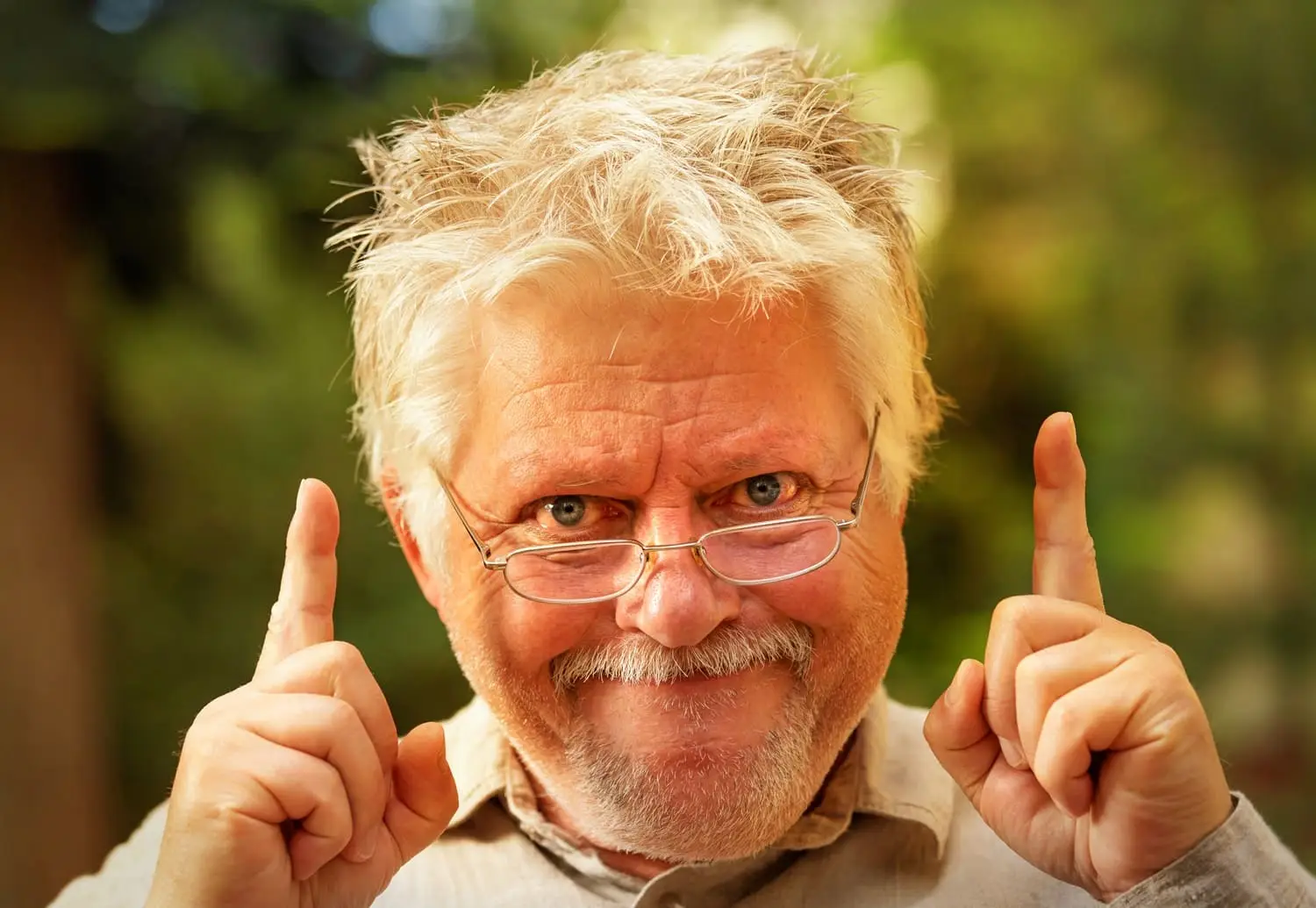 Photo of a man pointing as though he just had an idea