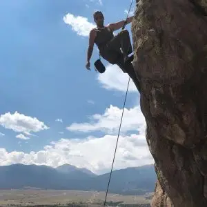 Photo of Allen Lundy rock climbing.