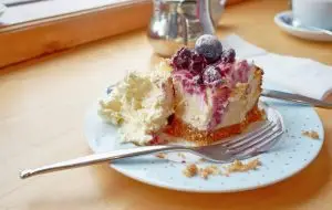 Photo of blueberry cheese cake topped with clotted cheese.