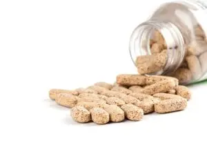 Photo of a bottle of open multivitamin pills