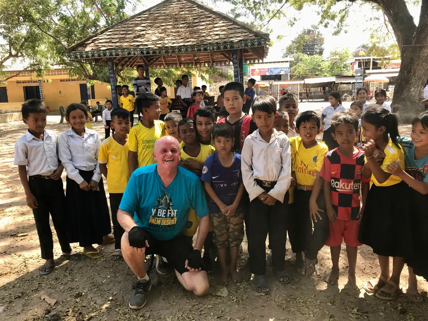 Jeff-with-children-in-a-village-he-visited-while-Lifewater-Internationals-2020-Ride-for-Clean-Water-Across-Cambodia-