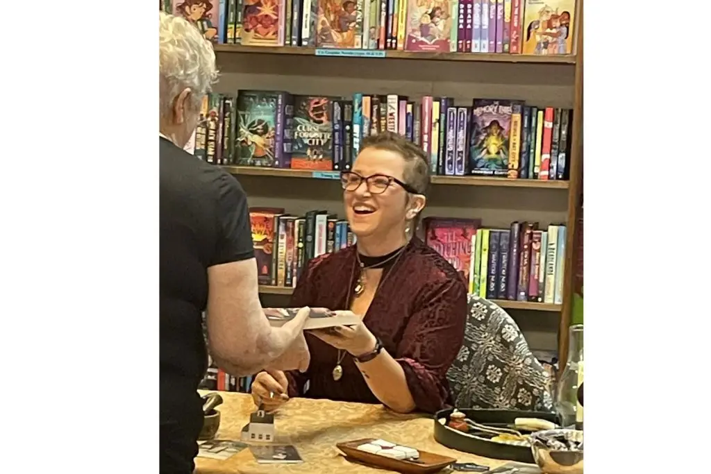 Julia Park Tracey signs books at a local bookstore.