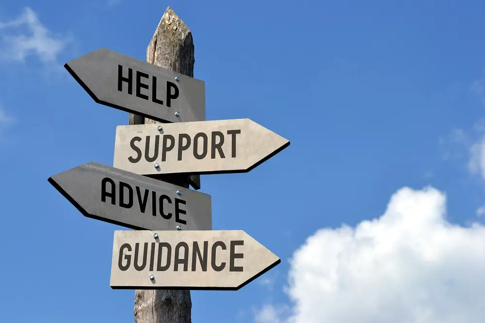 Photo of sign post offering help, support, advice and guidance.