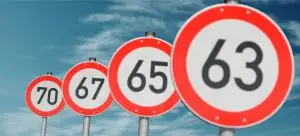 Photo of signs showing various retirement ages.