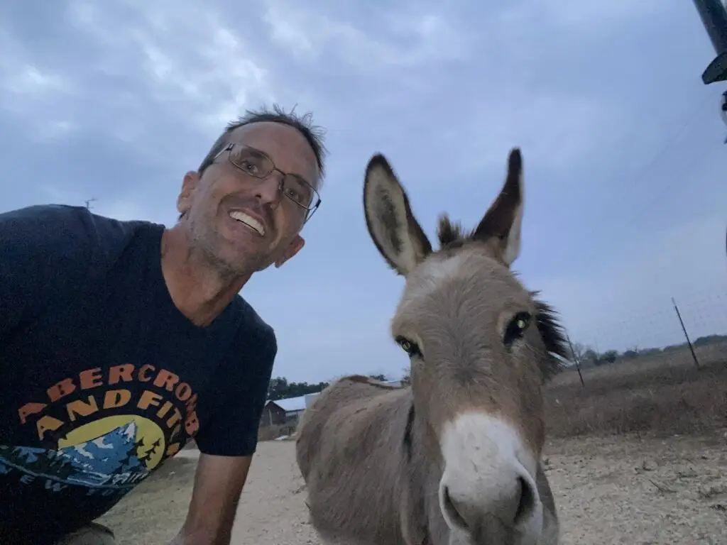Jim Bartleman with George, a donkey he met on a Hipcamp farm. 